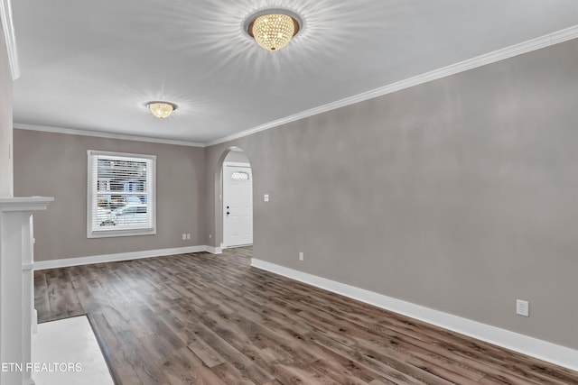 unfurnished living room with dark wood-type flooring and crown molding