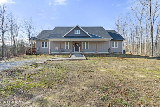 view of front facade featuring covered porch and a front lawn