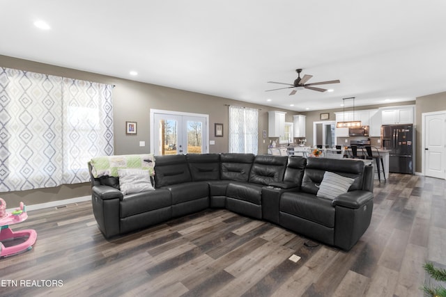 living room with ceiling fan, french doors, and wood-type flooring