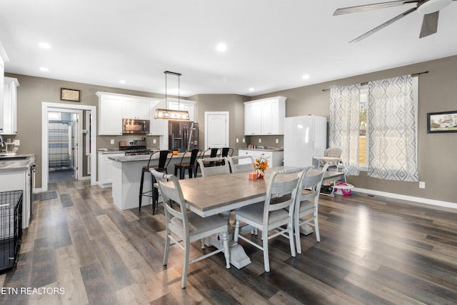 dining area with dark hardwood / wood-style floors and ceiling fan