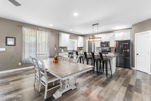 dining area featuring dark hardwood / wood-style floors and sink