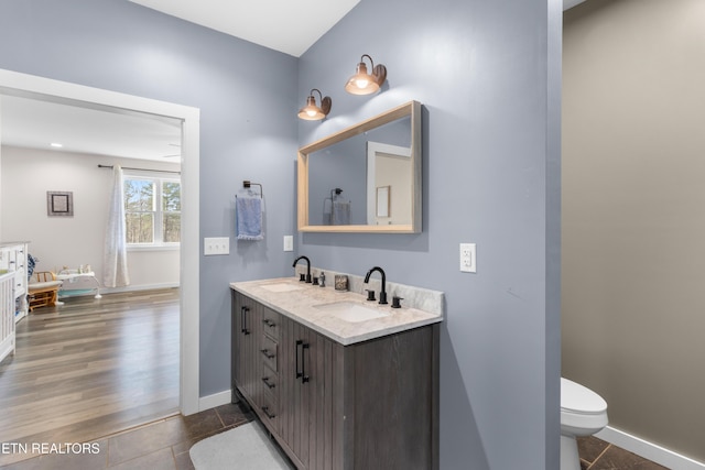 bathroom with tile patterned flooring, vanity, and toilet