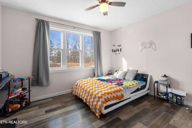 bedroom with dark hardwood / wood-style flooring and ceiling fan