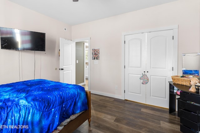 bedroom with a closet and dark wood-type flooring