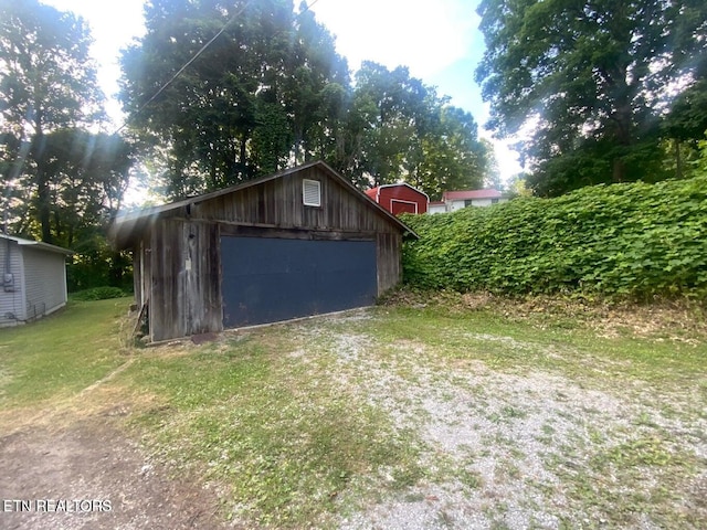 view of outbuilding featuring a garage and a yard