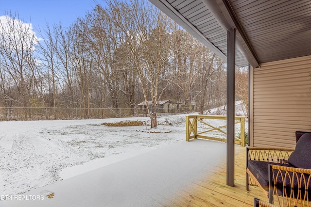 snow covered deck with fence