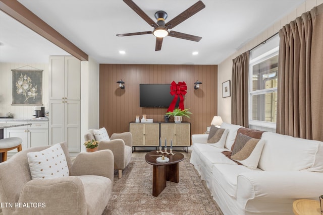 living room featuring recessed lighting, ceiling fan, and wooden walls