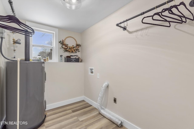 laundry room featuring hookup for a washing machine, electric dryer hookup, light wood-type flooring, laundry area, and baseboards