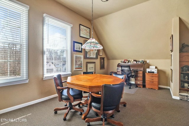 carpeted home office featuring vaulted ceiling