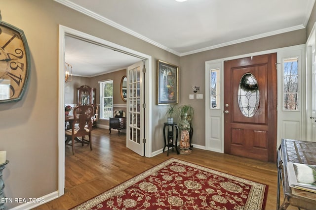 entryway with ornamental molding, a healthy amount of sunlight, and hardwood / wood-style floors