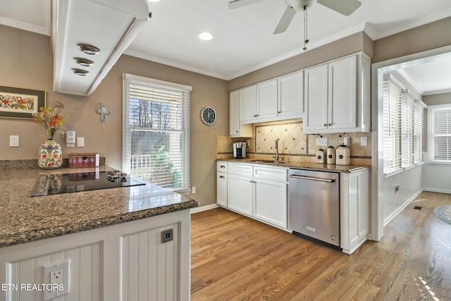 kitchen with stainless steel dishwasher, sink, light wood-type flooring, white cabinets, and black electric cooktop