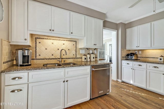 kitchen with white cabinets, backsplash, and stainless steel dishwasher