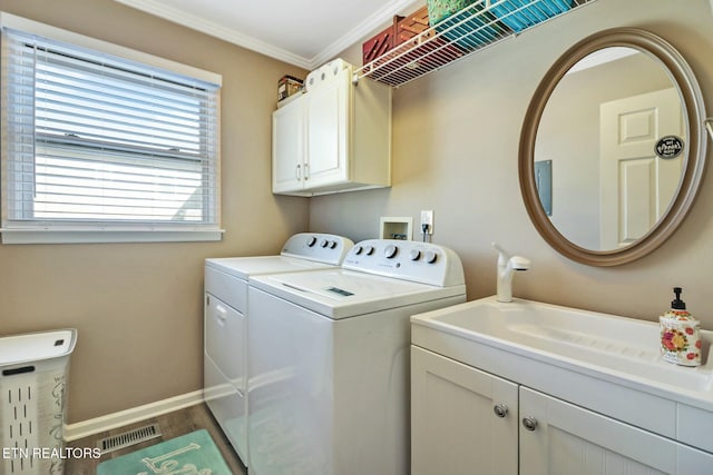 laundry room featuring washer and clothes dryer, ornamental molding, dark hardwood / wood-style floors, and cabinets