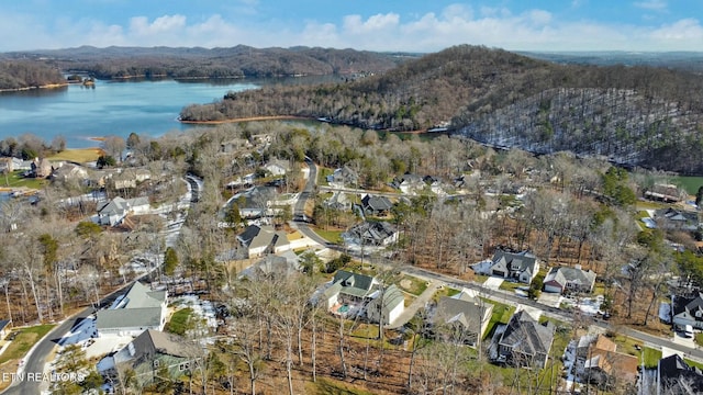 birds eye view of property with a water and mountain view