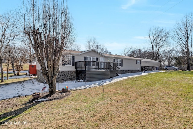 ranch-style house featuring a deck and a front yard