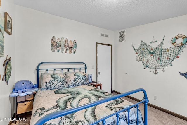 bedroom with a textured ceiling and carpet floors