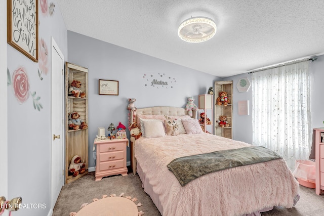 carpeted bedroom featuring a textured ceiling