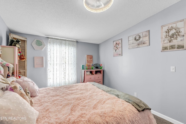 carpeted bedroom with a textured ceiling