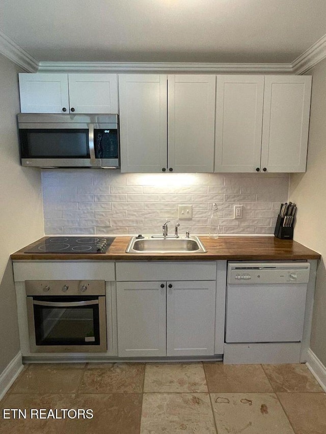 2733 Jersey Ave Unit C302, Knoxville, TN 37919 - kitchen featuring white cabinetry, sink, stainless steel appliances, backsplash, and ornamental molding
