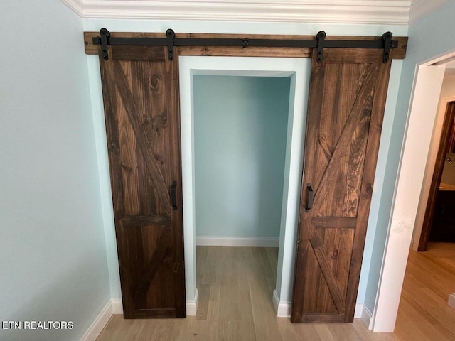 2733 Jersey Ave Unit C302, Knoxville, TN 37919 - hallway featuring a barn door, light hardwood / wood-style floors, and ornamental molding