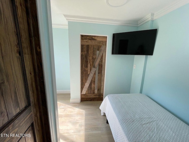 2733 Jersey Ave Unit C302, Knoxville, TN 37919 - bedroom with a barn door, light hardwood / wood-style flooring, and ornamental molding