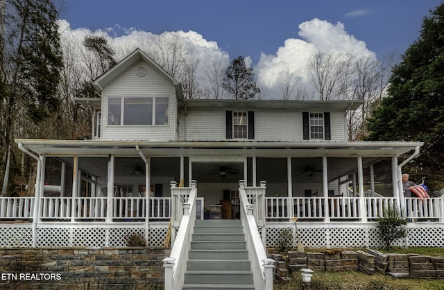 farmhouse inspired home with ceiling fan and covered porch