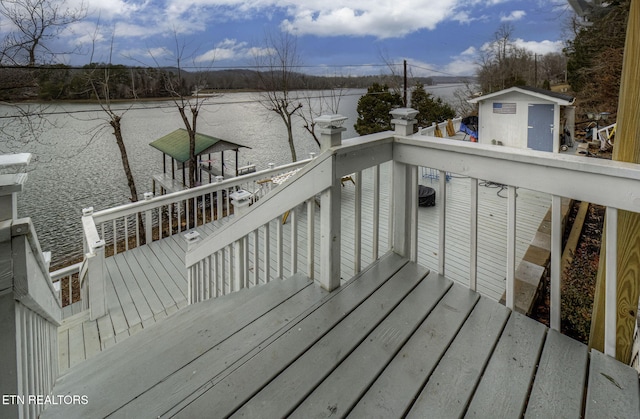 wooden terrace featuring a water view