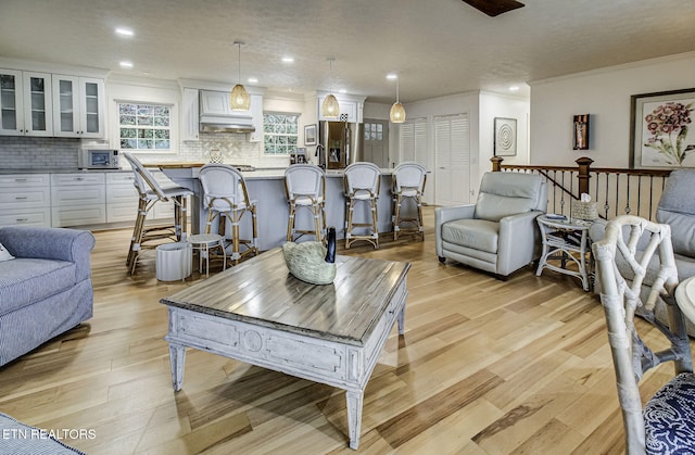 living room featuring light hardwood / wood-style floors and ornamental molding