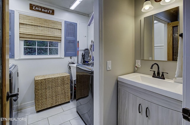 bathroom with tile patterned floors, vanity, and independent washer and dryer