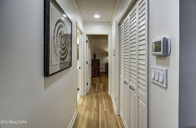 hallway featuring light hardwood / wood-style flooring and ornamental molding