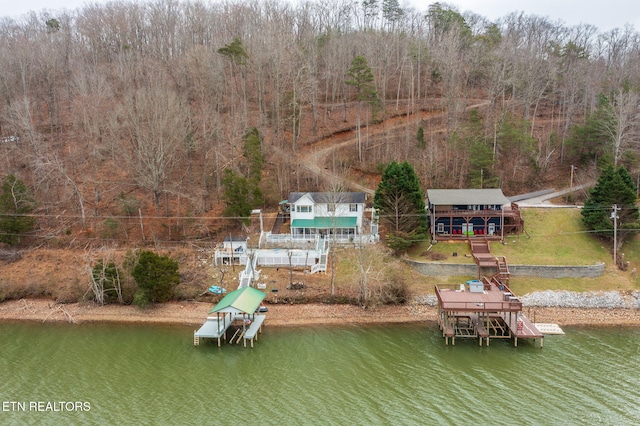 dock area with a yard and a deck with water view