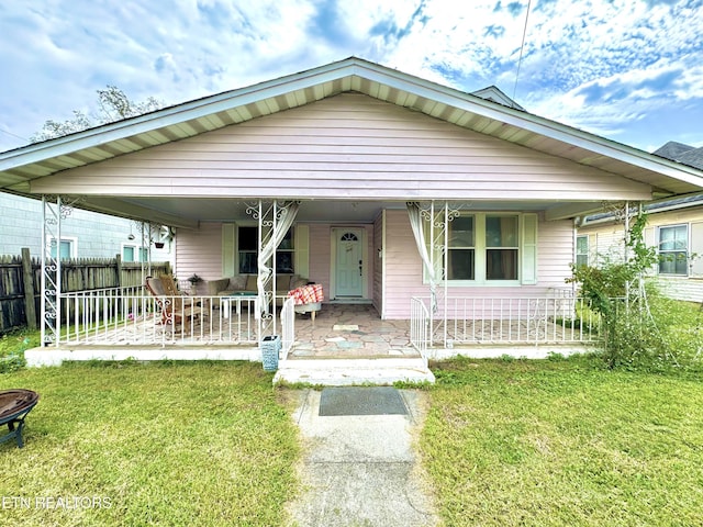 view of front of home featuring a front yard and a porch