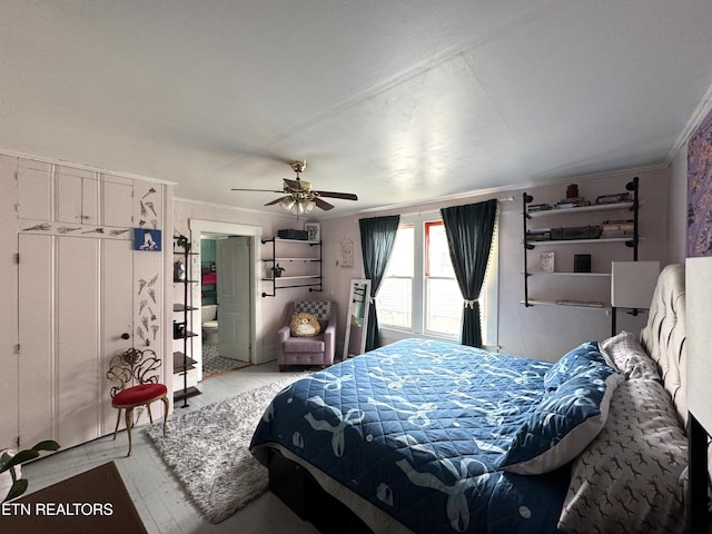 bedroom with ceiling fan, ornamental molding, connected bathroom, and wood-type flooring