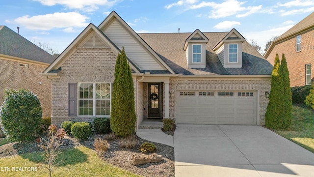 621 Dunlin Ln, Knoxville, TN 37934 - view of front facade featuring brick siding, driveway, a shingled roof, and an attached garage