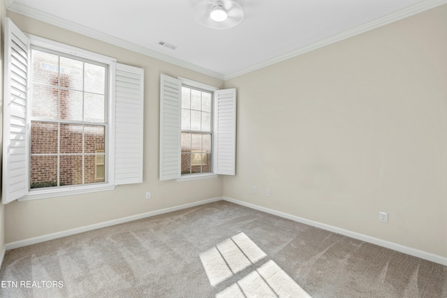 carpeted empty room featuring crown molding and a healthy amount of sunlight