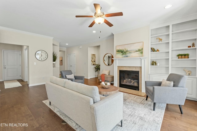 living room featuring ornamental molding, hardwood / wood-style floors, and ceiling fan