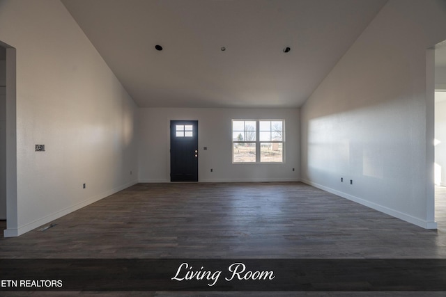 foyer with vaulted ceiling and dark hardwood / wood-style floors