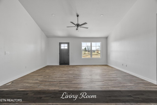 foyer entrance featuring ceiling fan, vaulted ceiling, baseboards, and wood finished floors