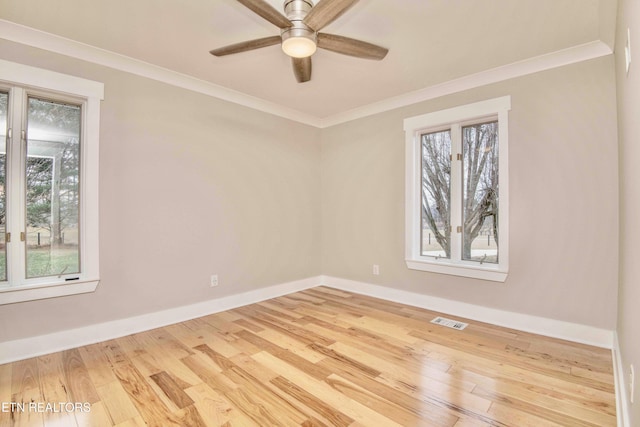 spare room featuring ceiling fan, a healthy amount of sunlight, and light hardwood / wood-style floors