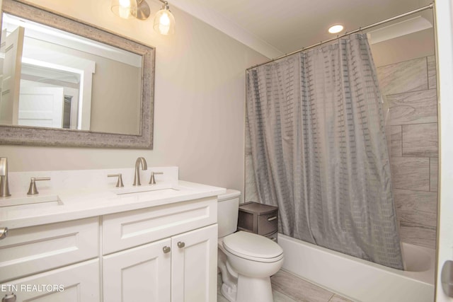 full bathroom featuring toilet, shower / bath combo with shower curtain, vanity, and ornamental molding