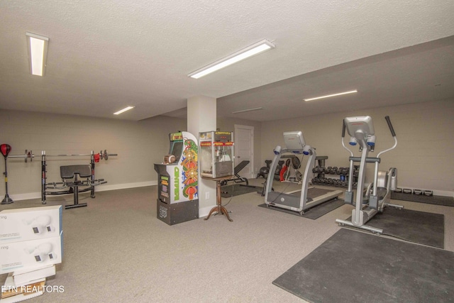 workout room featuring carpet flooring and a textured ceiling