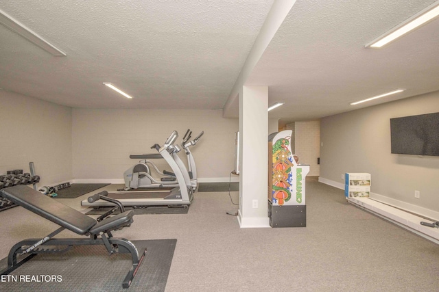 exercise area featuring a textured ceiling