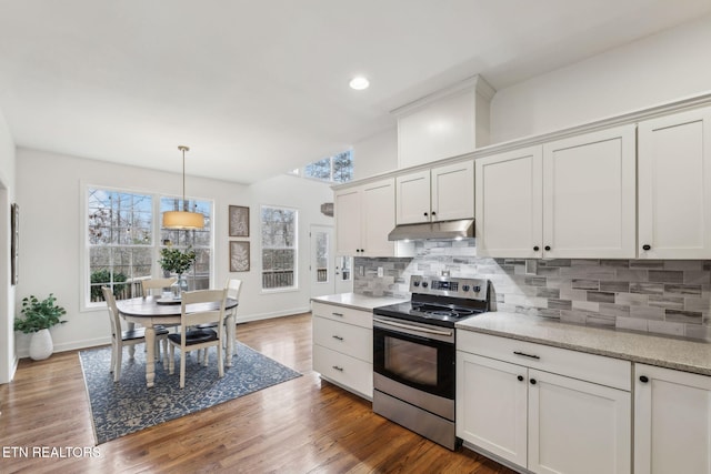 kitchen featuring white cabinets, electric stove, hanging light fixtures, decorative backsplash, and dark hardwood / wood-style flooring