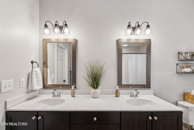 bathroom featuring vanity, toilet, and curtained shower