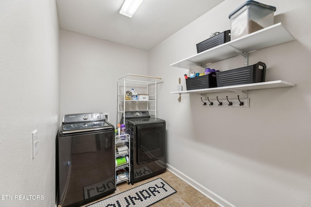 laundry area featuring separate washer and dryer and light tile patterned floors