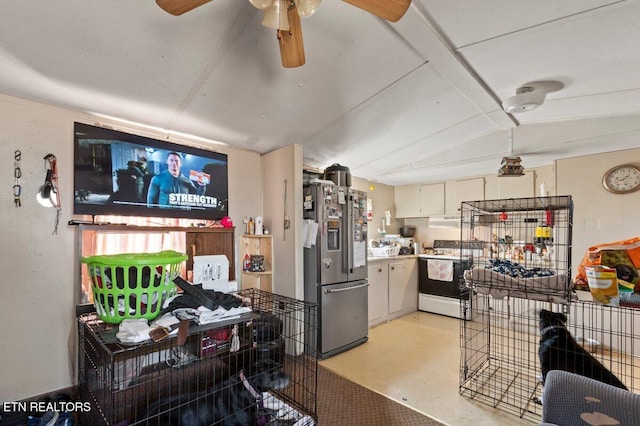 kitchen with stainless steel fridge, electric range, white cabinetry, and ceiling fan