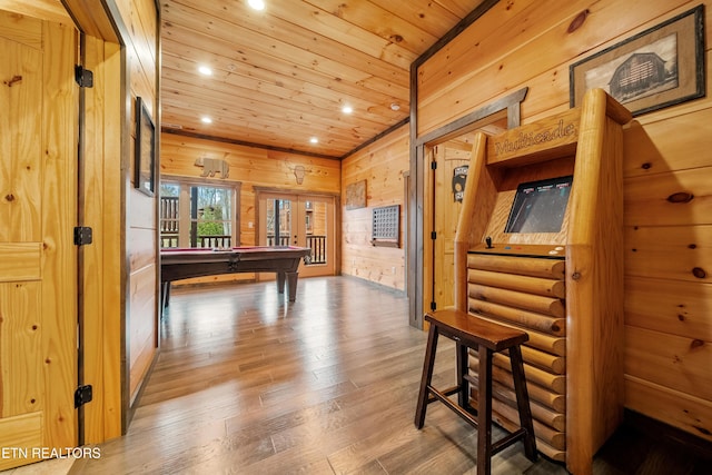 corridor with wood walls, wood ceiling, lofted ceiling, and hardwood / wood-style flooring