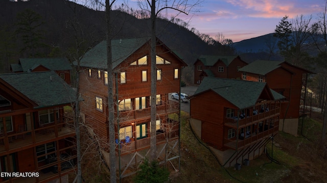 back house at dusk featuring a mountain view