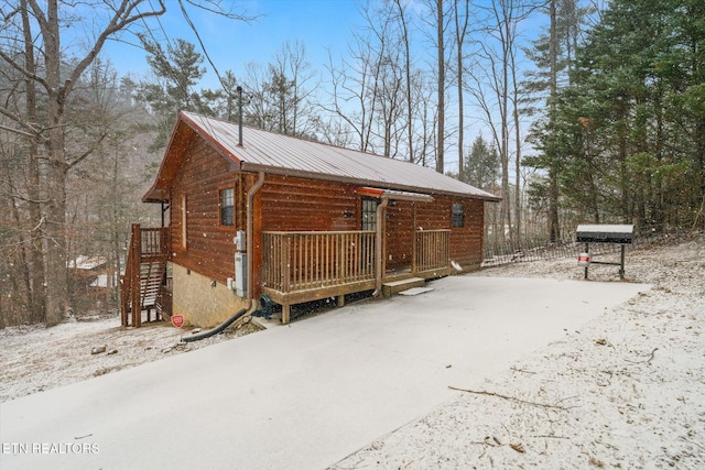 snow covered property with a deck