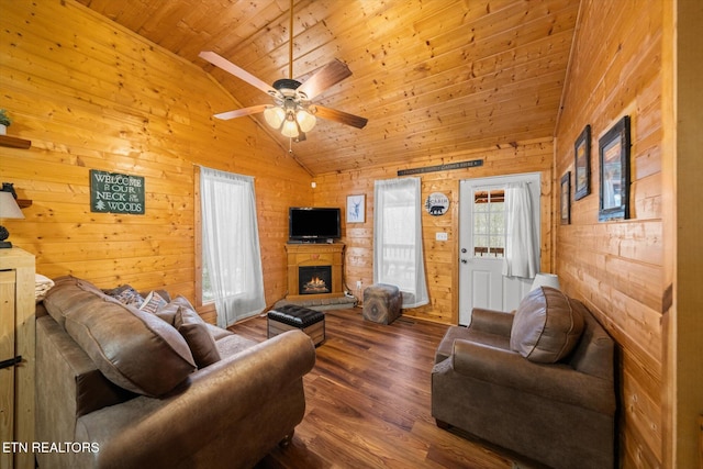 living room with wooden walls, dark hardwood / wood-style flooring, ceiling fan, and wood ceiling